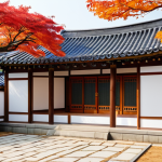 A breathtakingly serene traditional Korean Hanok in the autumn, bathed in warm, soft sunlight. The meticulously crafted wooden structure features elegant *giwa* tiled roofs and softly glowing *hanji* paper windows. A minimalist courtyard garden is adorned with vibrant red and orange maple trees, enhancing the tranquil atmosphere. The scene captures the essence of peaceful living, with natural light and harmonious composition. Professional architectural photography, high quality, perfect architecture, correct proportions, natural setting, safe for work, appropriate content, fully clothed, professional, family-friendly.